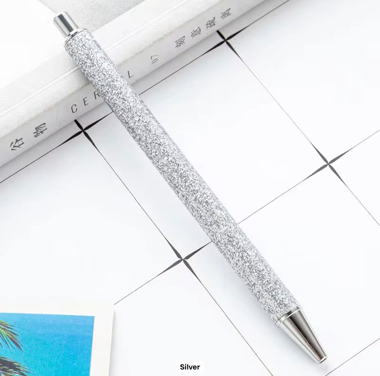 Glitter metal retractable ballpoint pen.