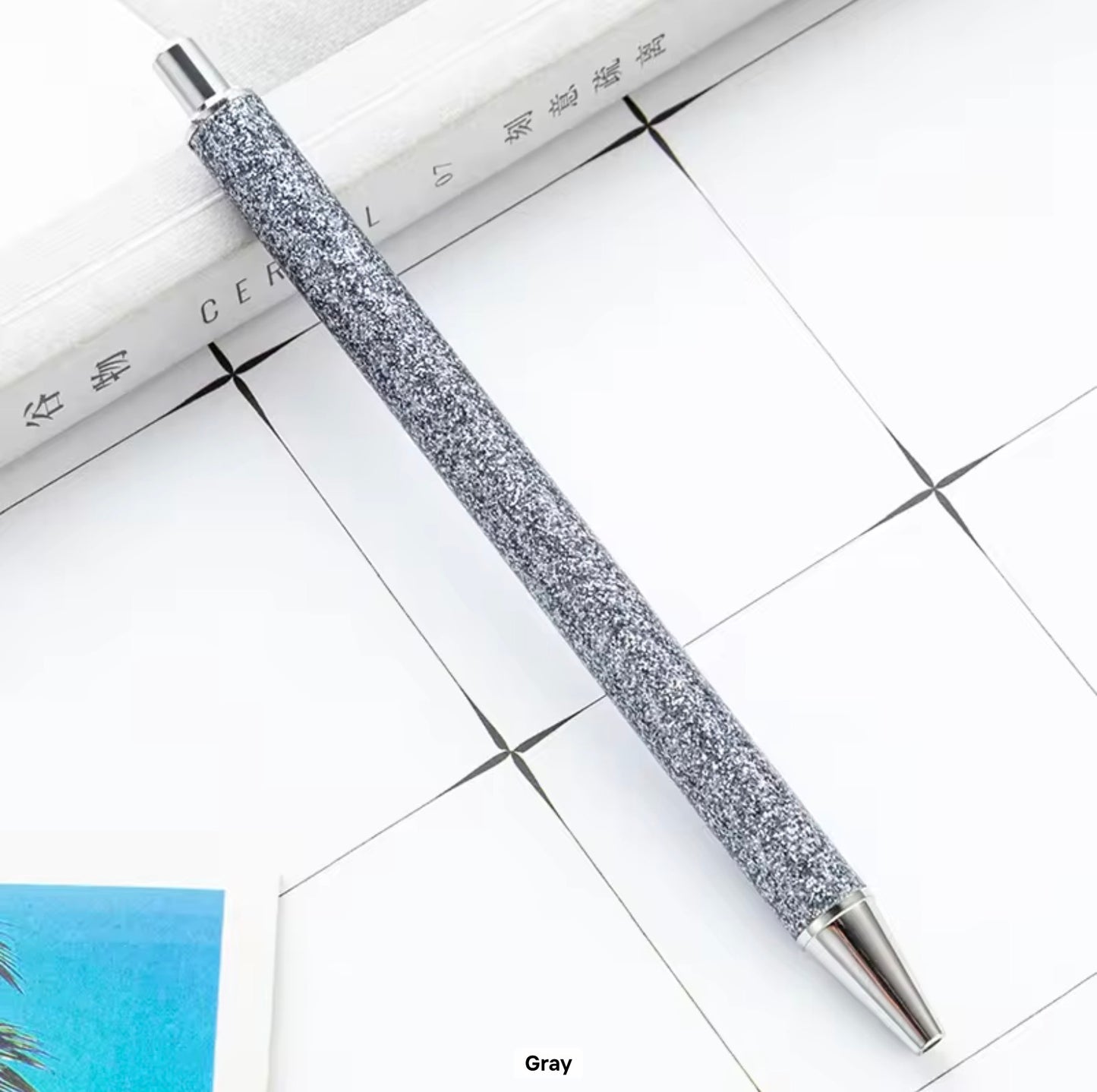 Glitter metal retractable ballpoint pen.
